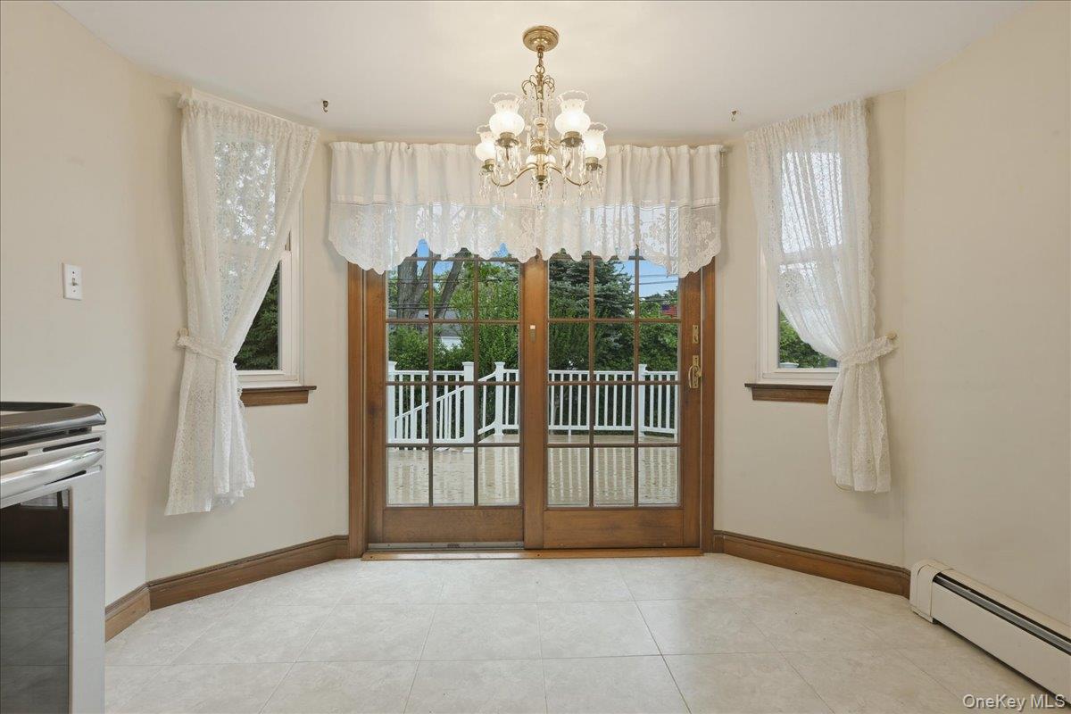 17 Avon Road Farmingdale, NY 11735 - Photo 14 of 46 a view of a hallway with windows and chandelier