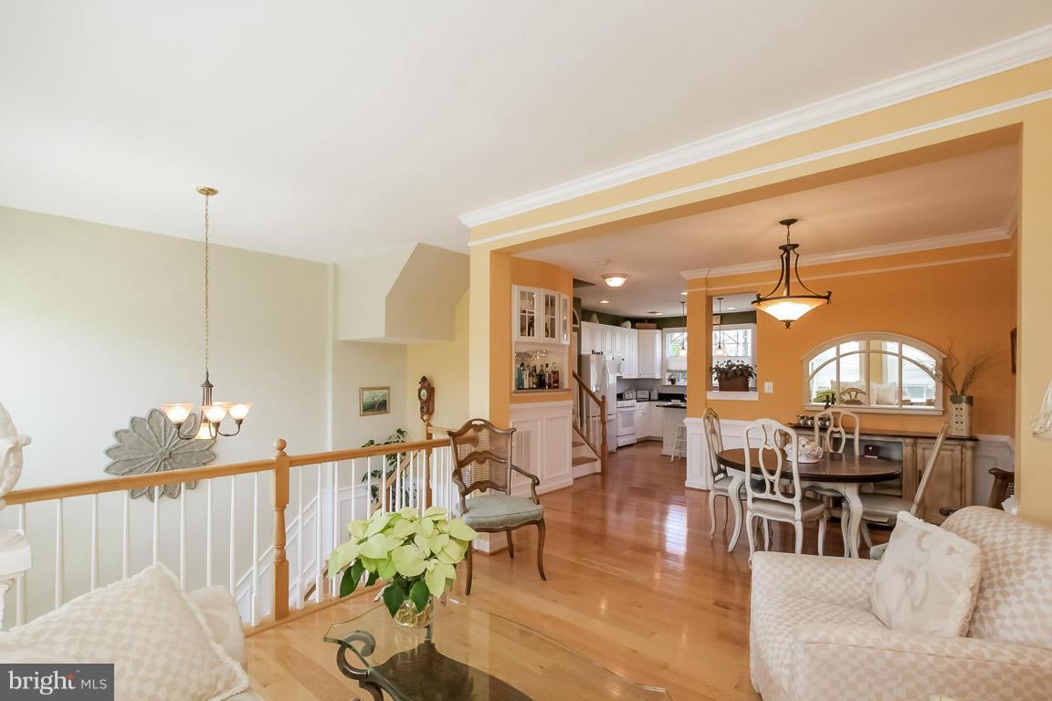 15626 Avocet Loop Woodbridge, VA 22191 - Photo 14 of 30 a living room with lots of furniture and a chandelier