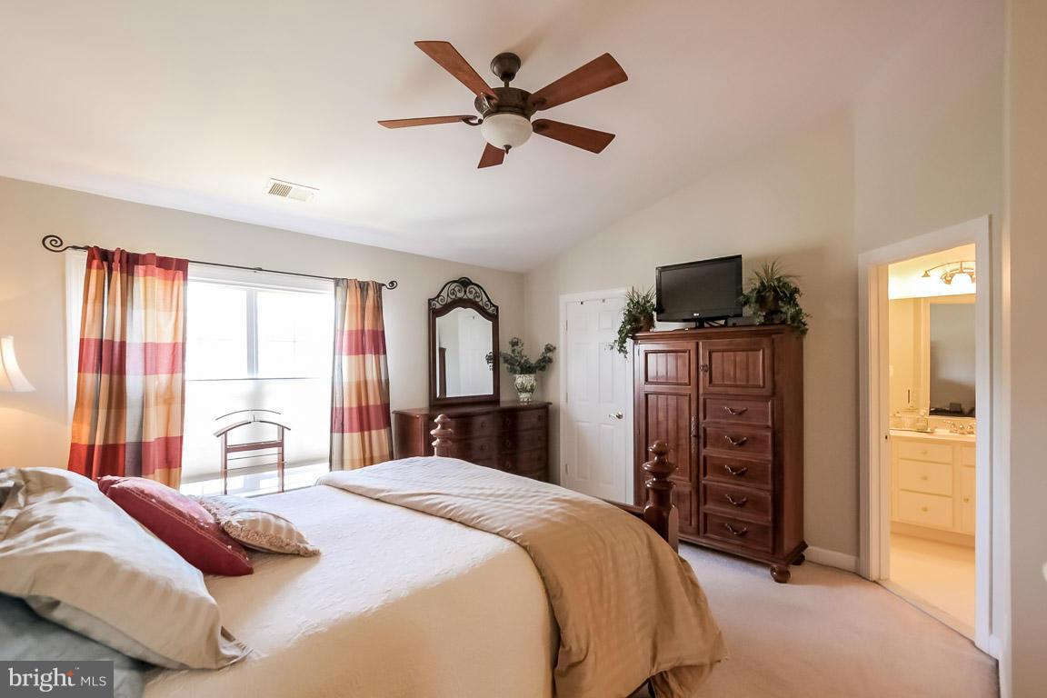 15626 Avocet Loop Woodbridge, VA 22191 - Photo 17 of 30 a bedroom with a large bed and a large window