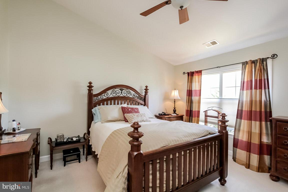 15626 Avocet Loop Woodbridge, VA 22191 - Photo 18 of 30 a bedroom with a bed and a large window