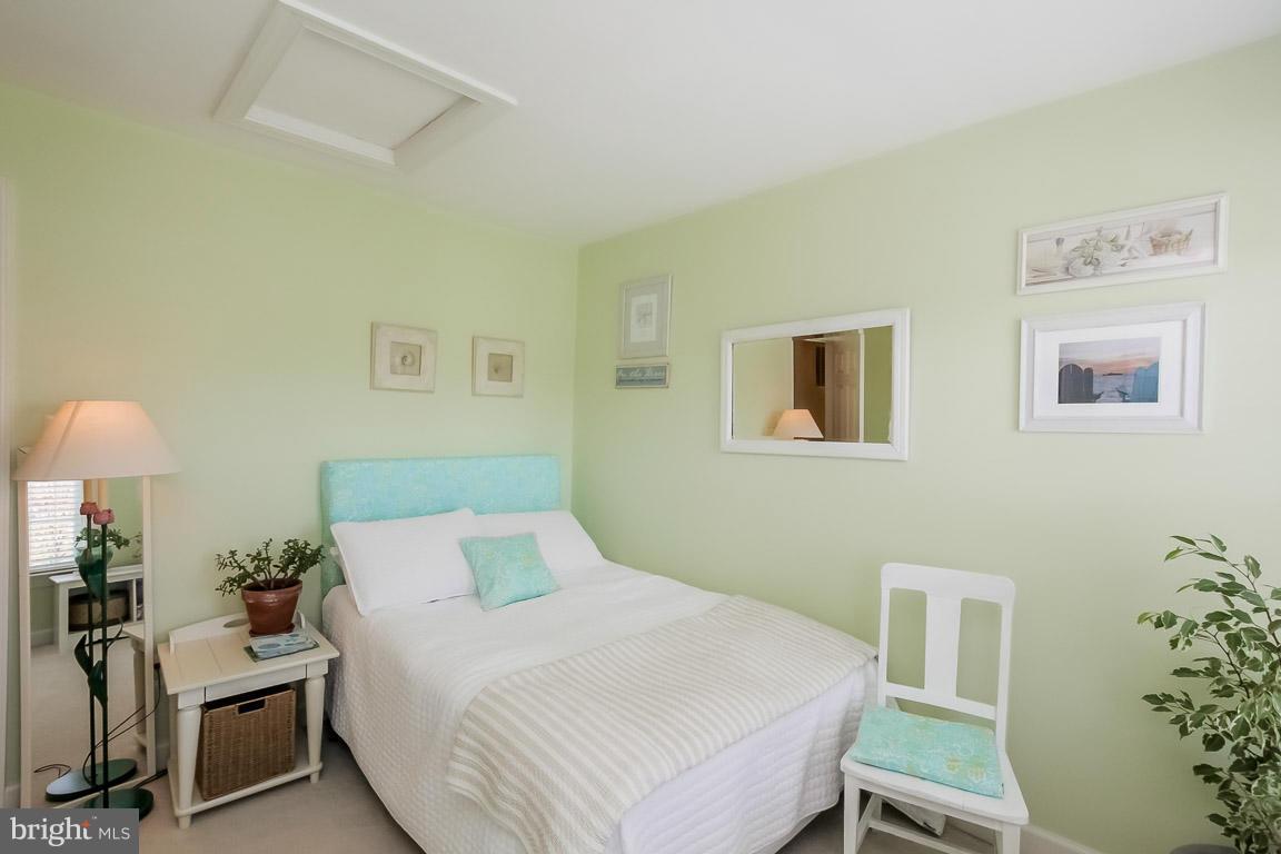 15626 Avocet Loop Woodbridge, VA 22191 - Photo 19 of 30 a bedroom with a bed and a table in it