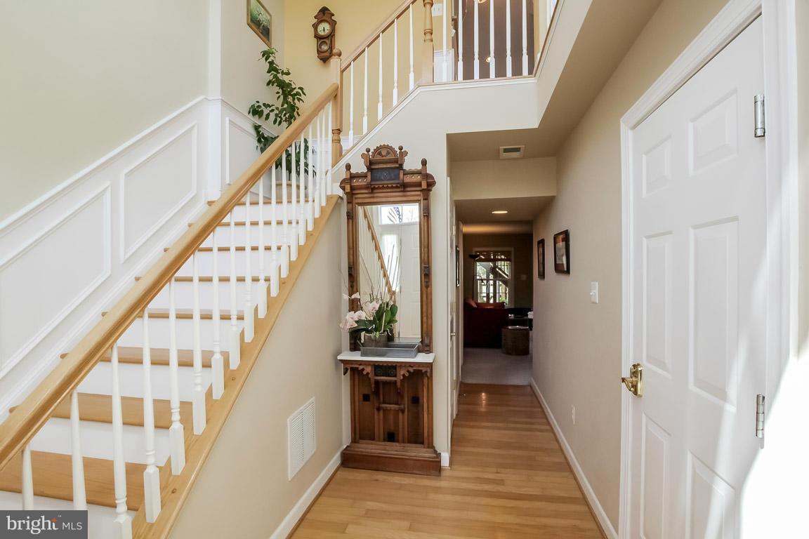 15626 Avocet Loop Woodbridge, VA 22191 - Photo 3 of 30 a view of a hallway with wooden floor and staircase