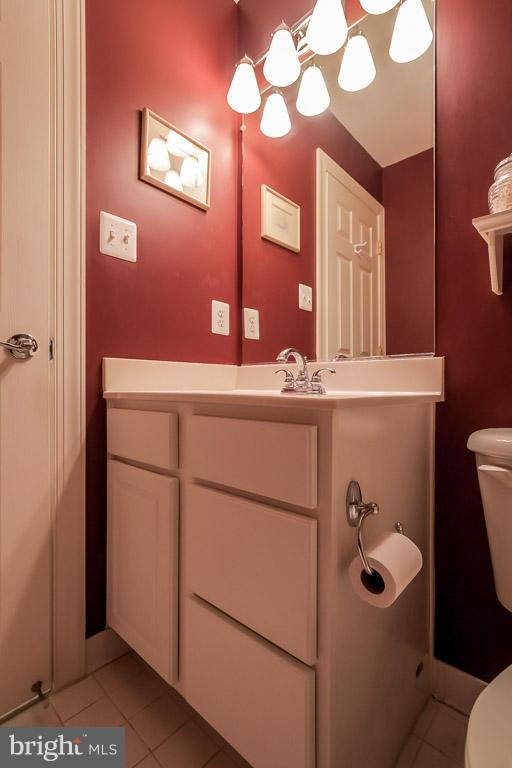 15626 Avocet Loop Woodbridge, VA 22191 - Photo 24 of 30 a bathroom with a sink a toilet and mirror