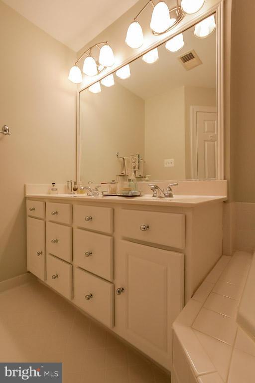 15626 Avocet Loop Woodbridge, VA 22191 - Photo 25 of 30 a room with a sink and a mirror