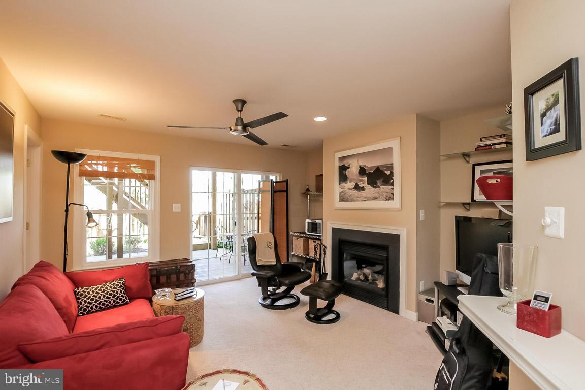 15626 Avocet Loop Woodbridge, VA 22191 - Photo 5 of 30 a living room with furniture a fireplace and a flat screen tv