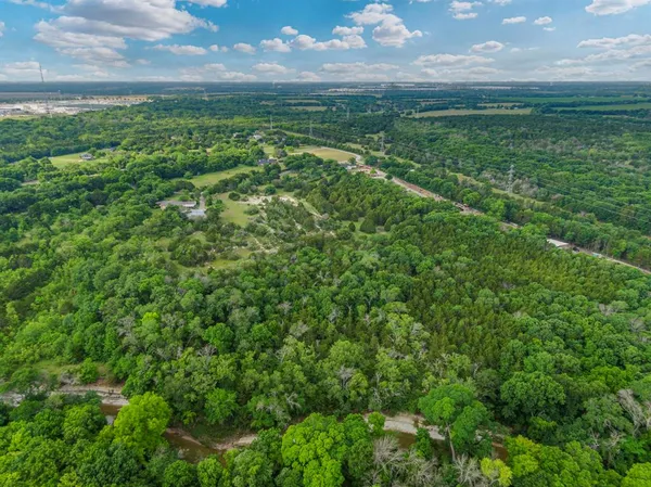a view of a big yard with lots of green space