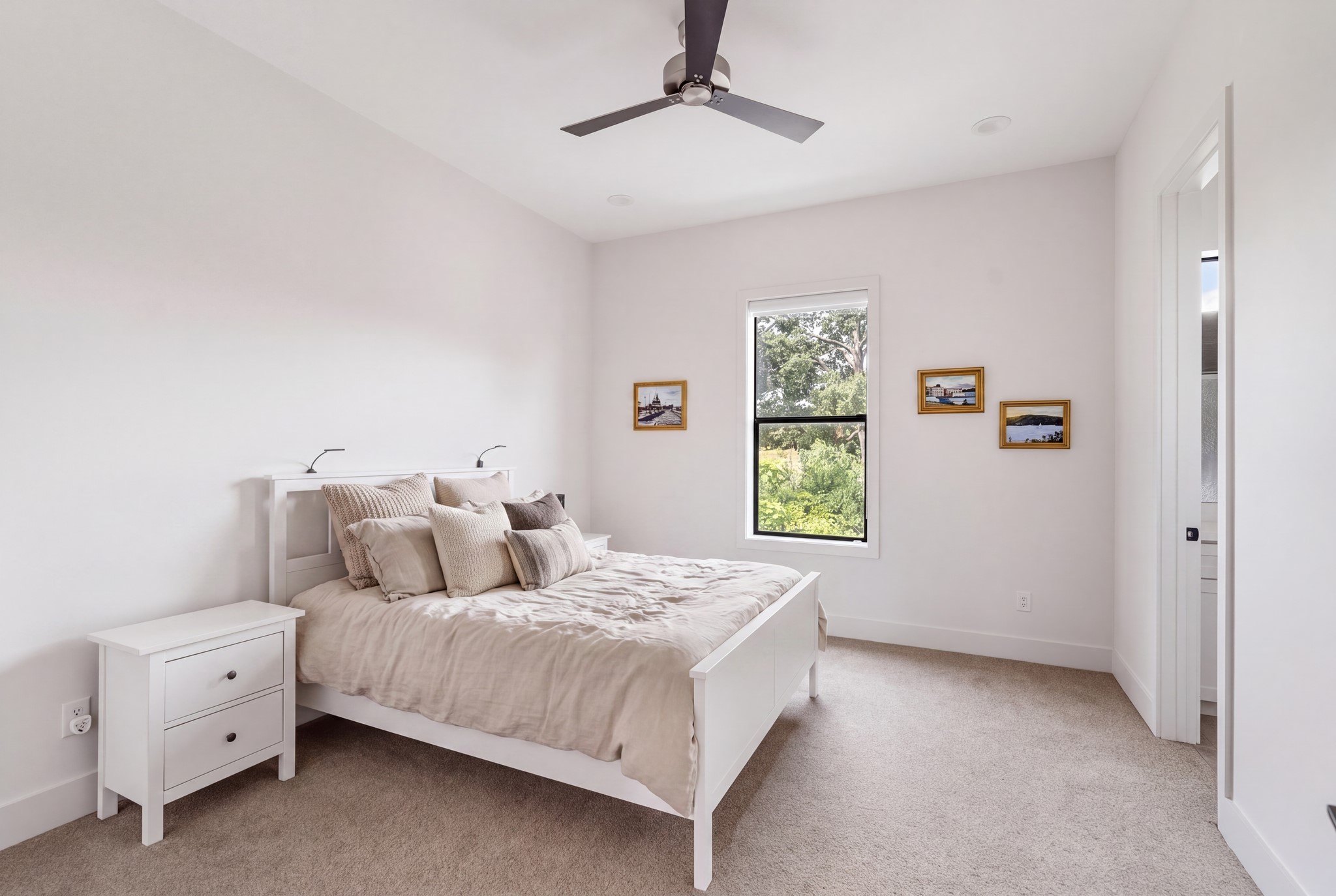 5427 Maple Street Houston, TX 77096 - Photo 32 of 46 A generously sized carpeted bedroom offers a large window bringing in ample natural light, with a ceiling fan overhead and clean, open wall space throughout.