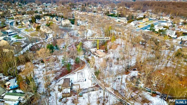 an aerial view of residential houses with yard