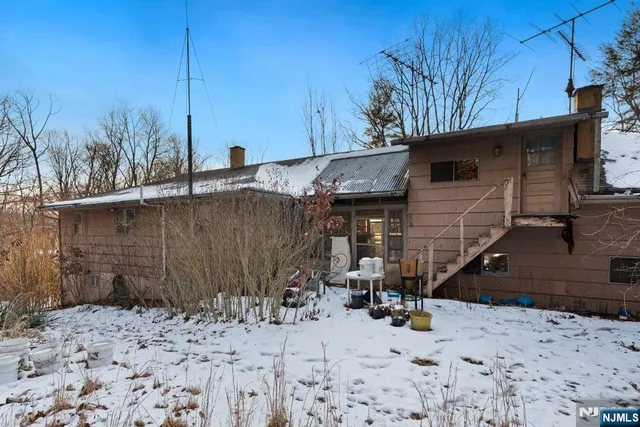 a view of a house with a snow on the road