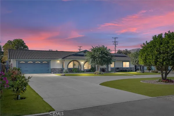 a front view of a house with a yard and a garage