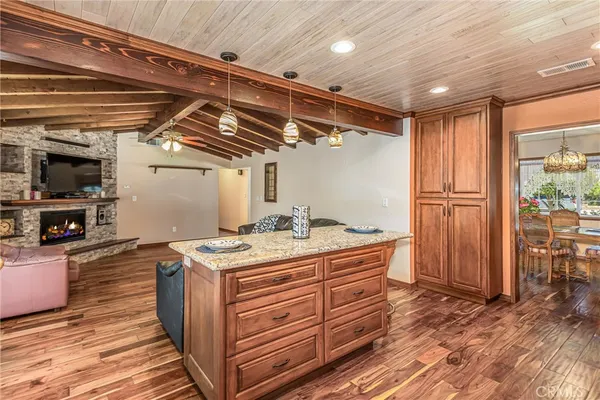 a kitchen with stainless steel appliances granite countertop a stove microwave and sink