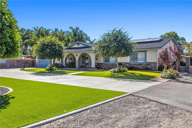 a view of a house with swimming pool and yard