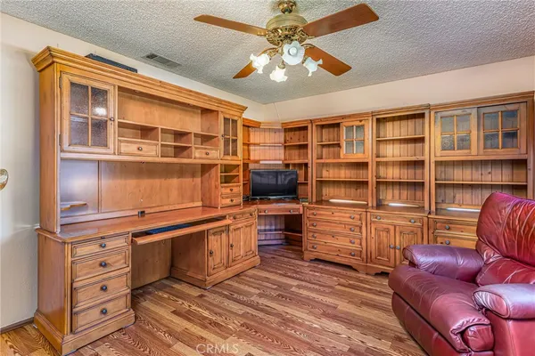a bedroom with a bed and dresser with mirror