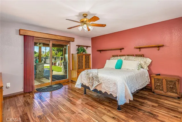 a bedroom with a bed and dresser with mirror