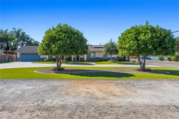 a view of a swimming pool with a house in the background