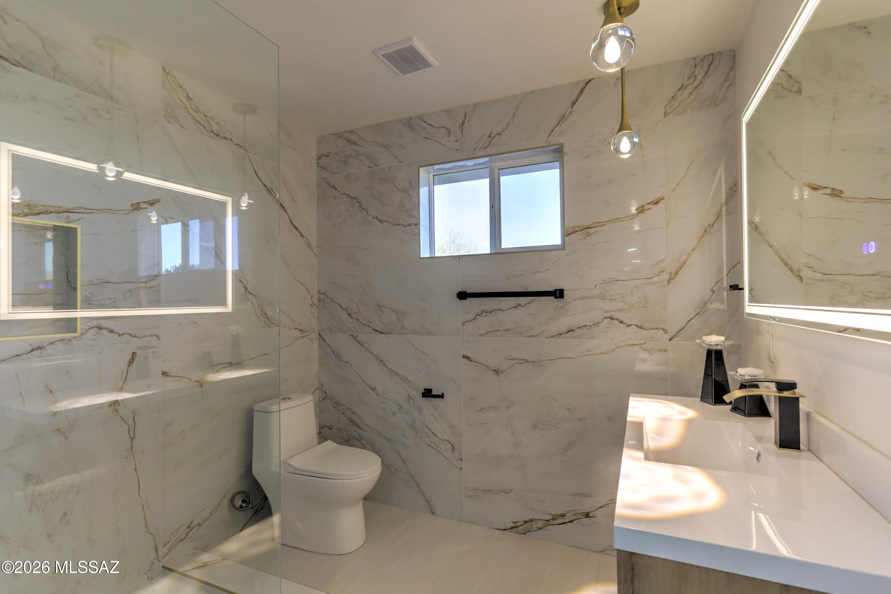 4939 East River Road Tucson, AZ 85718 - Photo 10 of 29 a bathroom with a toilet sink and mirror
