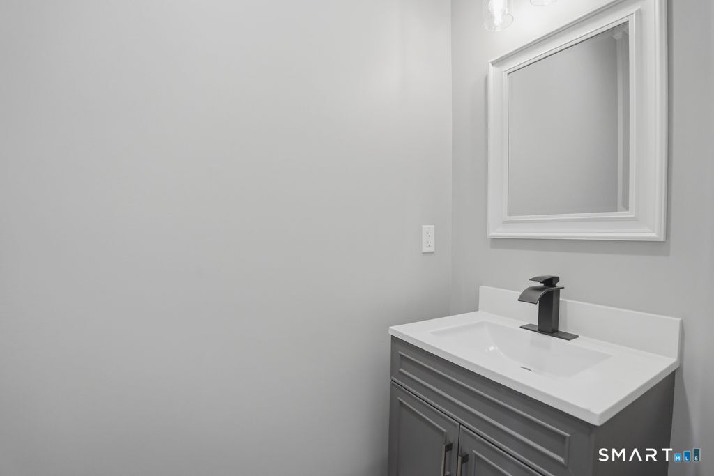 796 Maple Hill Road Naugatuck, CT 06770 - Photo 12 of 35 a bathroom with a sink a mirror and vanity