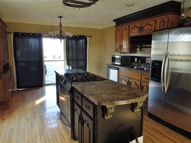 635 Hurricane Loop Tennessee Ridge, TN 37178 - Photo 9 of 20 Great kitchen! Hardwood flooring, nice cabinetry, center cook island and breakfast area.