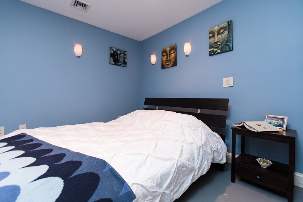 38 Conant Road Weston, MA 02493 - Photo 11 of 19 a bedroom with a bed and a lamp