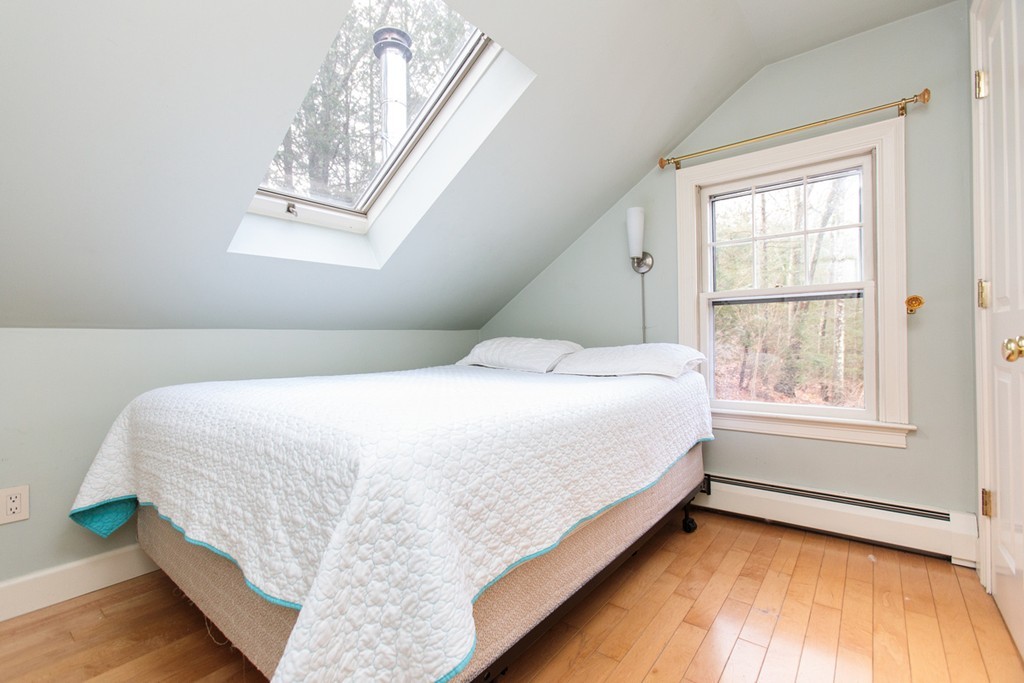 38 Conant Road Weston, MA 02493 - Photo 18 of 19 a large bed sitting in a bedroom next to a window