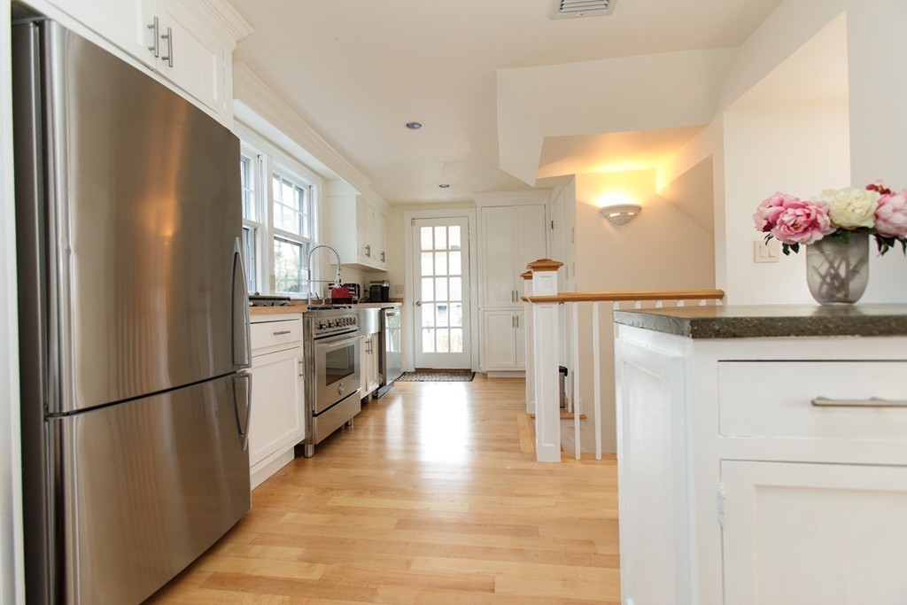 38 Conant Road Weston, MA 02493 - Photo 4 of 19 a kitchen with stainless steel appliances granite countertop a refrigerator a stove and a sink with wooden floor