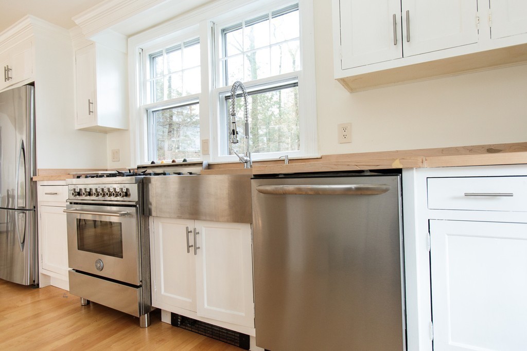 38 Conant Road Weston, MA 02493 - Photo 5 of 19 a kitchen with a sink stove and cabinets