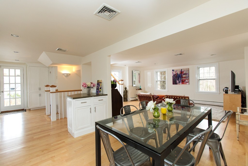 38 Conant Road Weston, MA 02493 - Photo 10 of 19 a living room with furniture a dining table chairs wooden floor and kitchen view