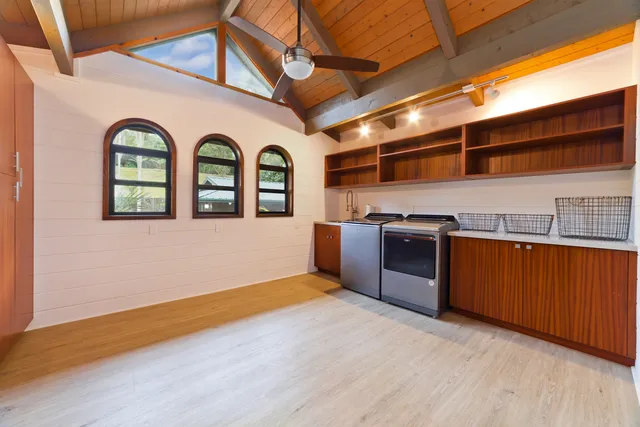 a view of a kitchen with stainless steel appliances granite countertop a stove a sink and a microwave