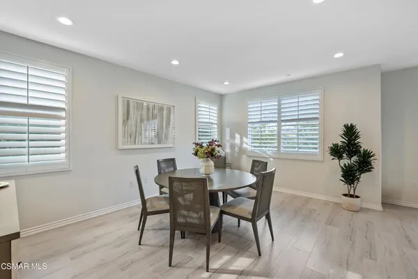 a view of a dining room with furniture and window