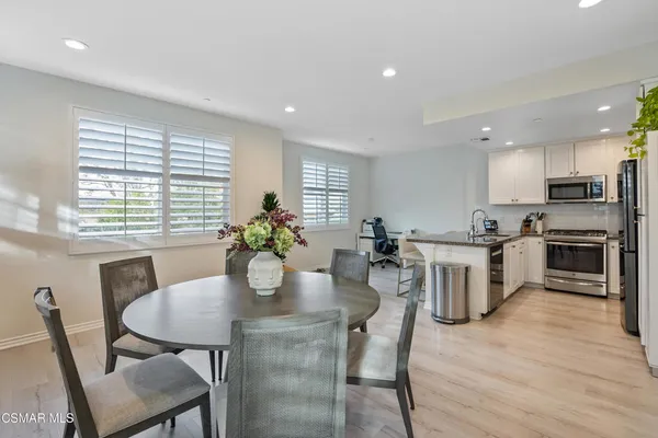 a view of a dining room with furniture and wooden floor