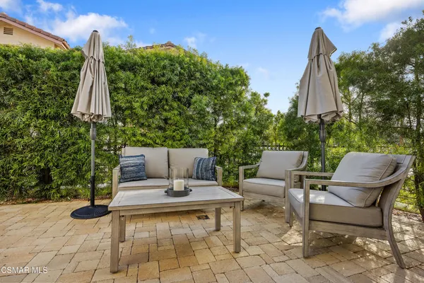 a view of a patio with a table and chairs