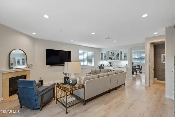 a living room with furniture flat screen tv and wooden floor