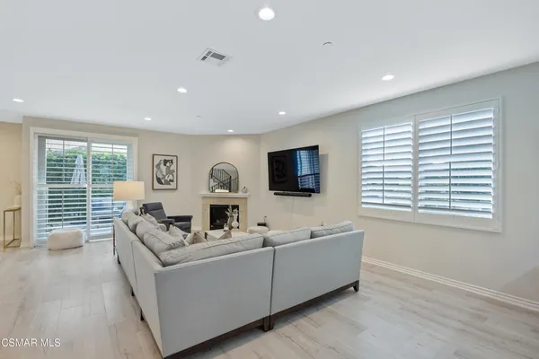 a living room with furniture tv and a window