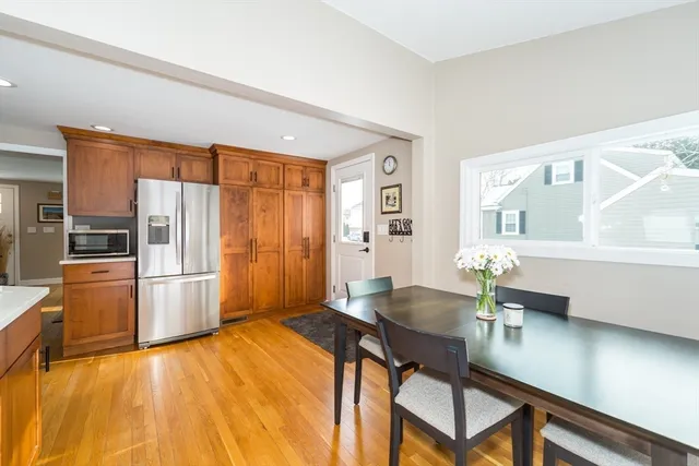 a kitchen with a table chairs refrigerator and cabinets