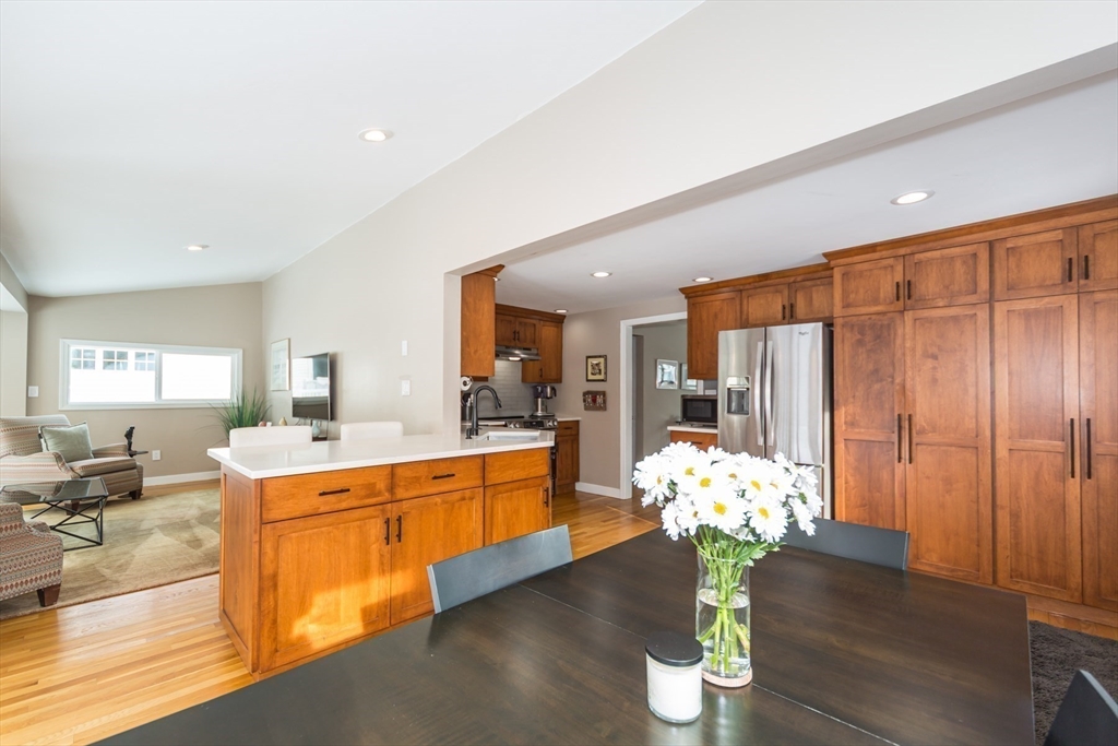 1 Lincoln Street Extension Natick, MA 01760 - Photo 12 of 31 a room with view of kitchen view with wooden floor dining table chairs and chandelier