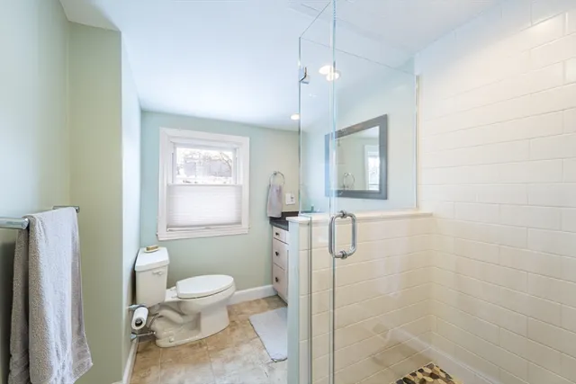 a bathroom with a toilet sink and shower