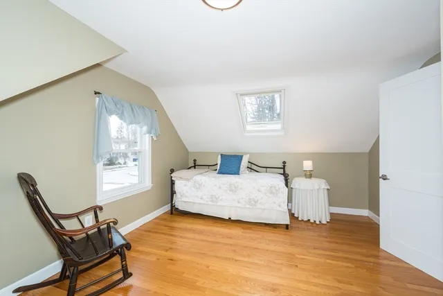 a spacious bedroom with a bed and a window