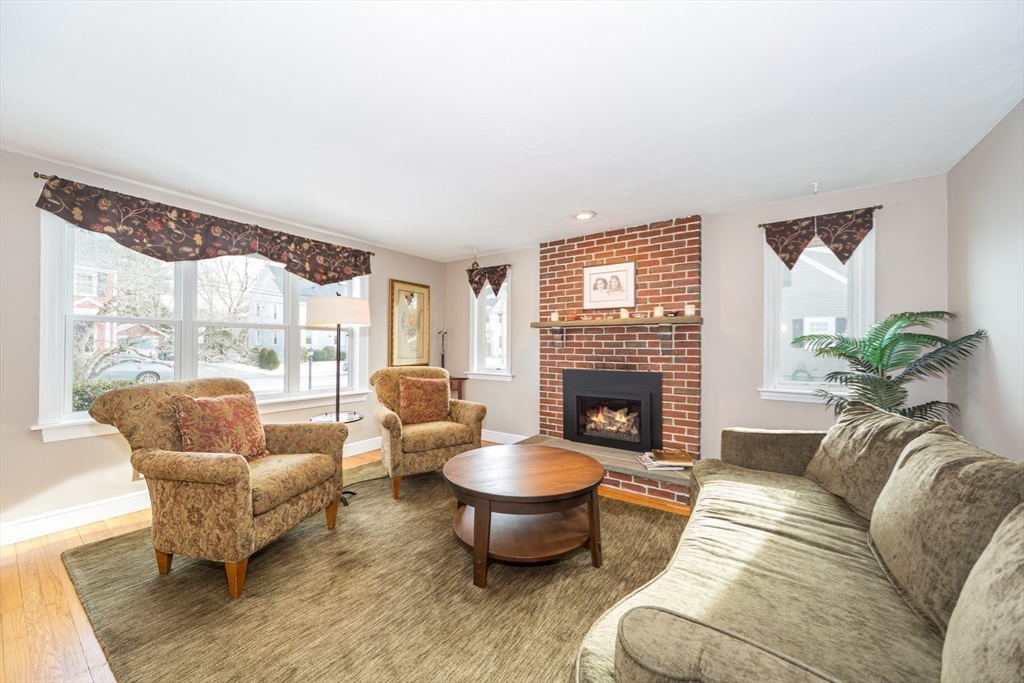 1 Lincoln Street Extension Natick, MA 01760 - Photo 5 of 31 a living room with furniture and a fireplace