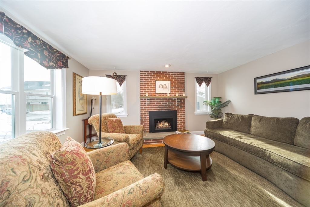 1 Lincoln Street Extension Natick, MA 01760 - Photo 6 of 31 a living room with furniture and a fireplace