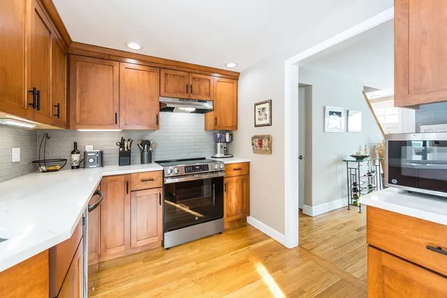 a kitchen with stainless steel appliances granite countertop a stove a sink and a refrigerator