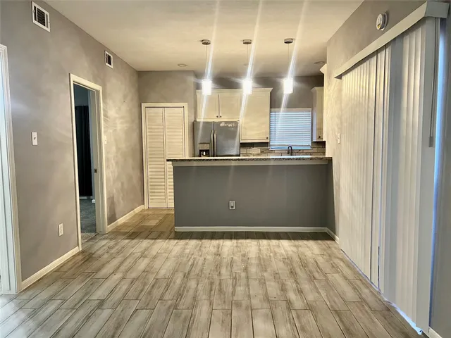 a kitchen with stainless steel appliances granite countertop a refrigerator and a sink