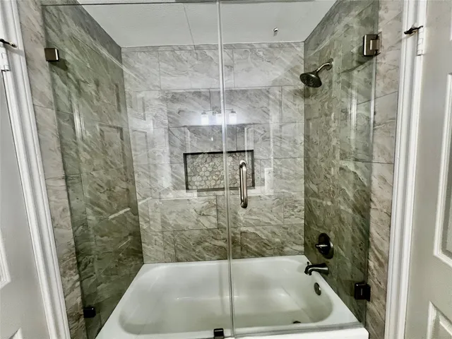 a bathroom with a shower and toilet