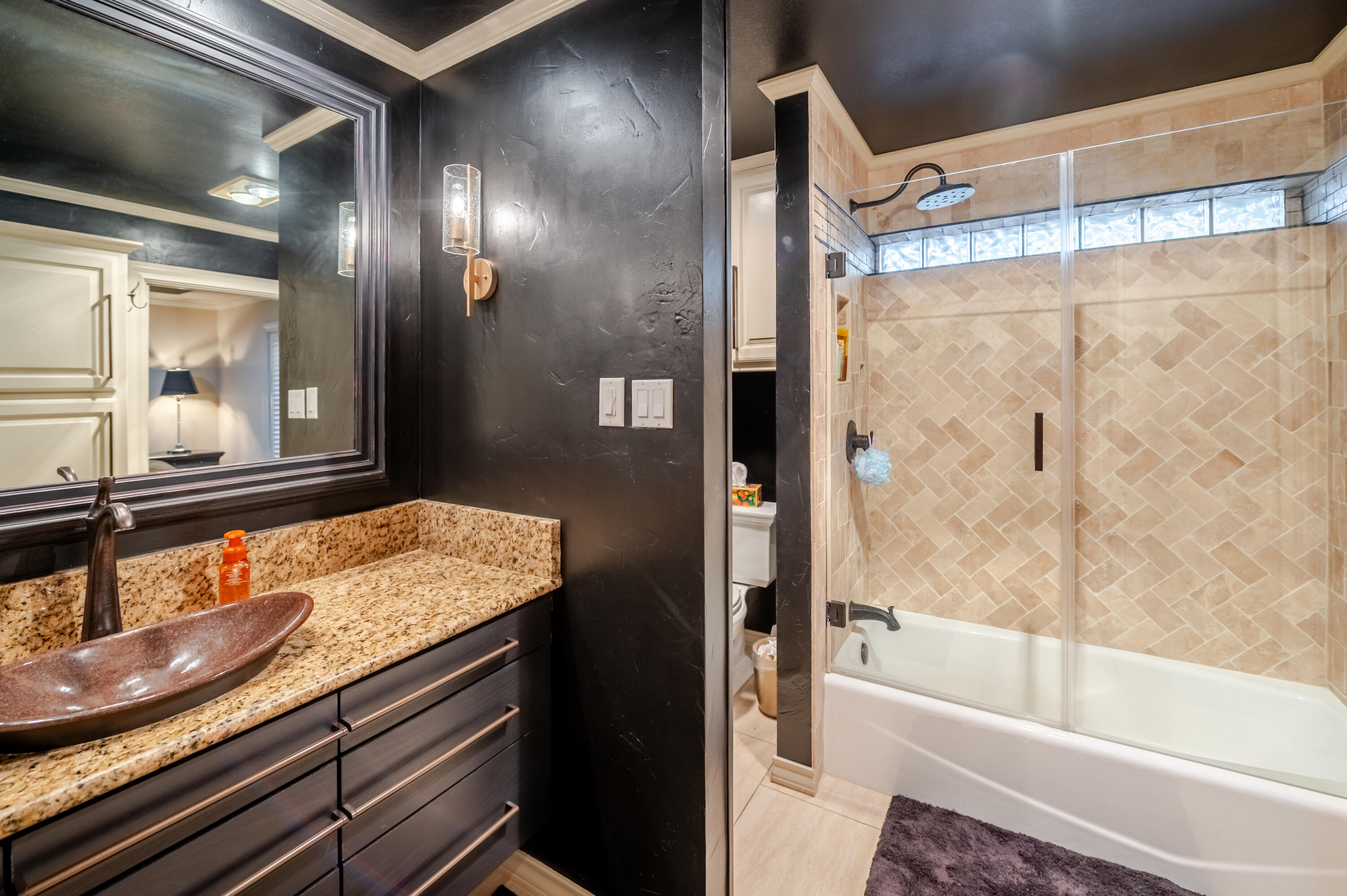 4226 97th Place Lubbock, TX 79423 - Photo 29 of 52 a bathroom with a granite countertop sink and a mirror
