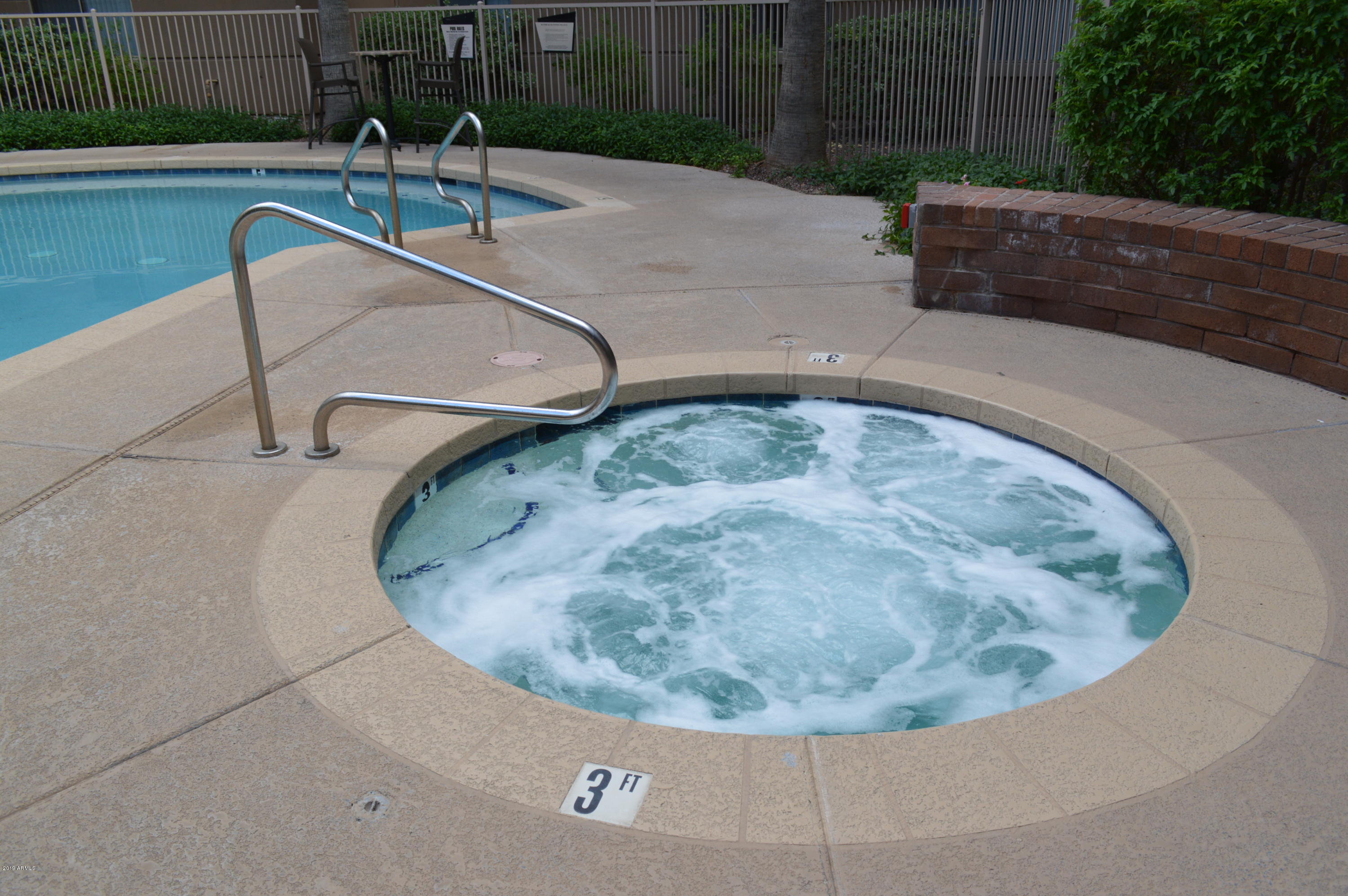 1701 East Colter Street, Unit 184 Phoenix, AZ 85016 - Photo 28 of 41 a view of a swimming pool with a sitting area