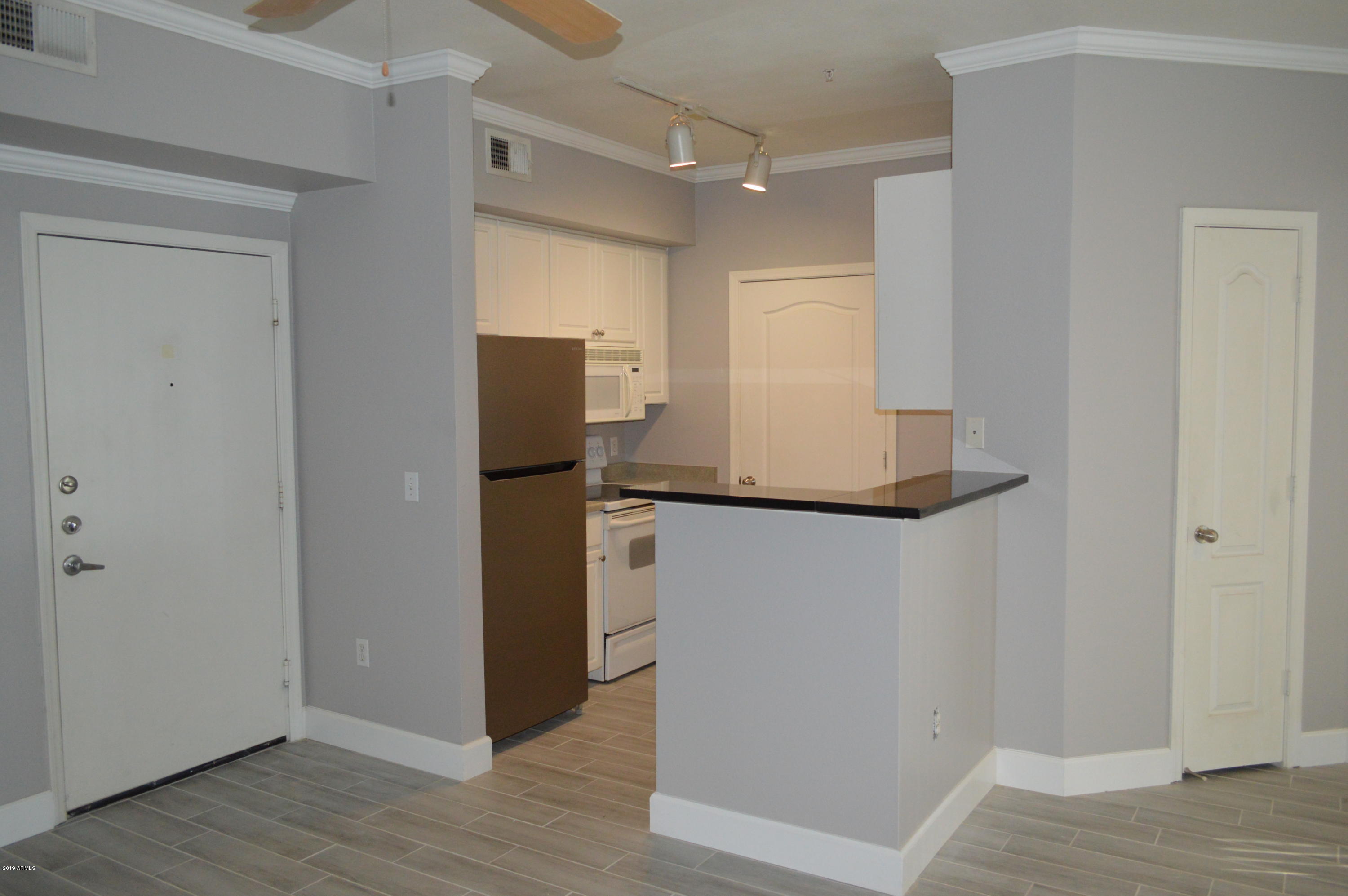 1701 East Colter Street, Unit 184 Phoenix, AZ 85016 - Photo 3 of 41 a view of a hallway with wooden floor