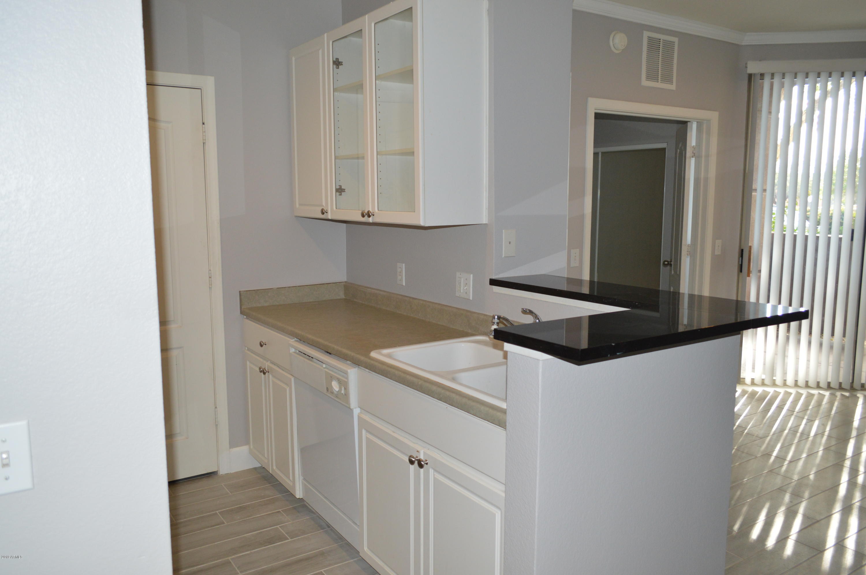 1701 East Colter Street, Unit 184 Phoenix, AZ 85016 - Photo 5 of 41 a kitchen with a sink and cabinets