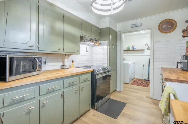 a kitchen with a refrigerator sink and cabinets