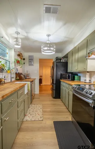 a large kitchen with kitchen island a sink stainless steel appliances and cabinets