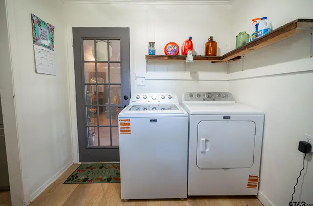 a utility room with fridge dryer and washer