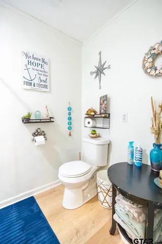 a bathroom with a granite countertop toilet a sink and a bathtub